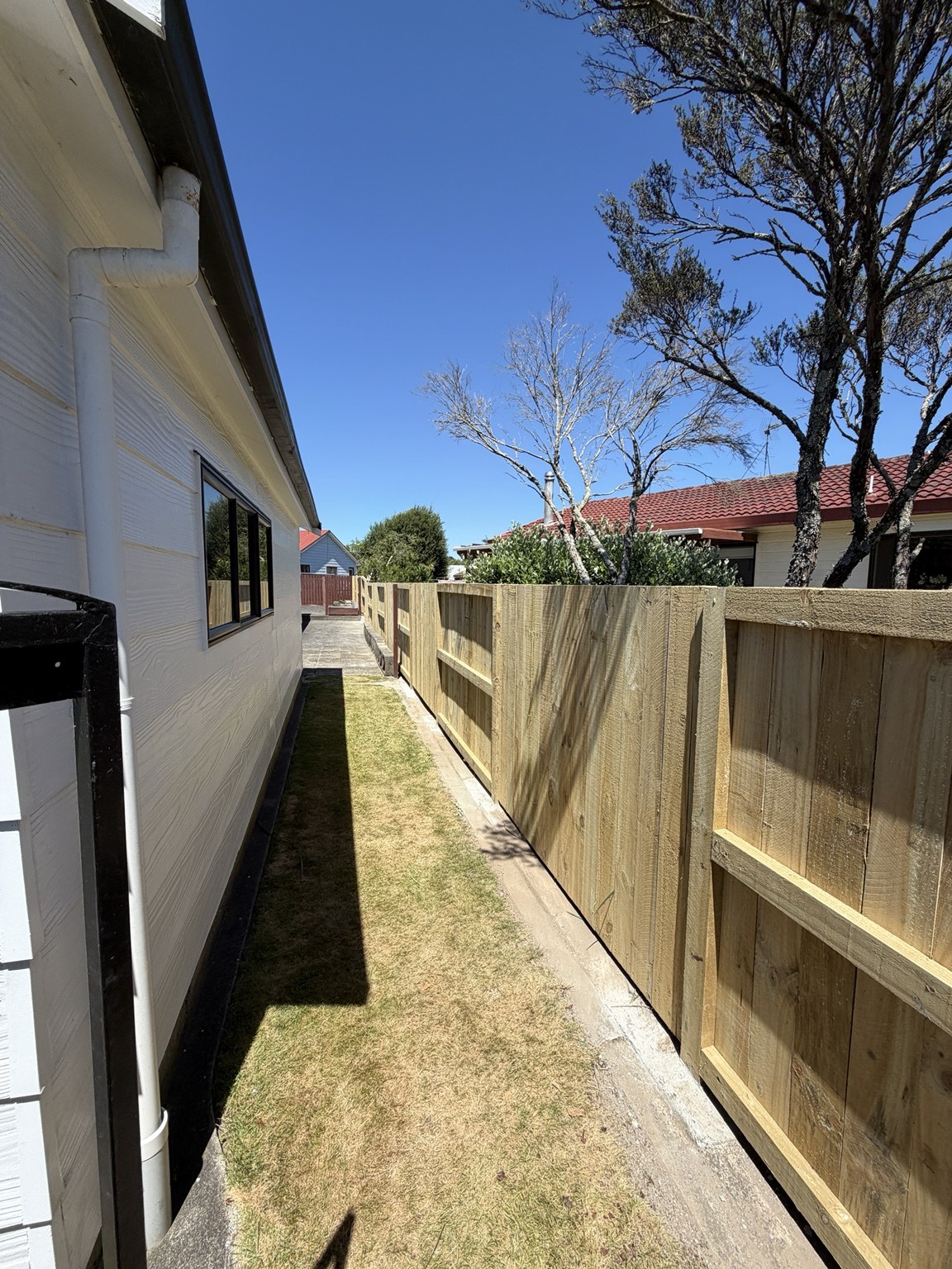 Timber paling fence alongside a home